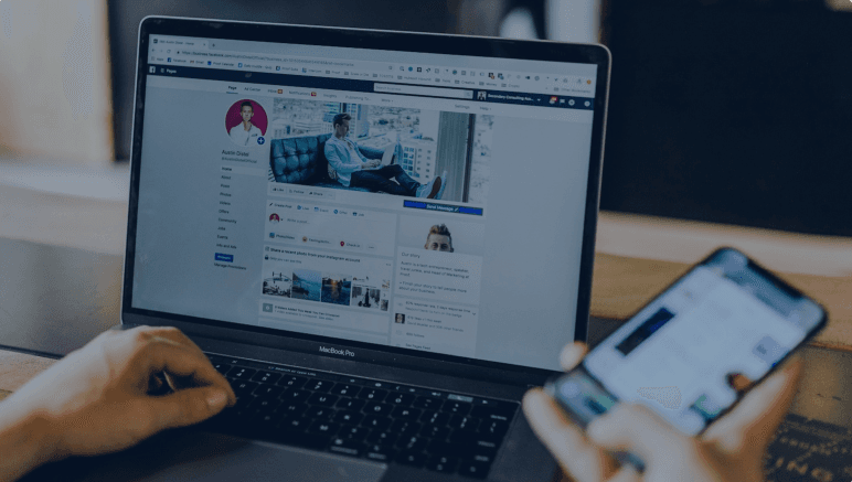 Person reviewing a social media page on a laptop and phone